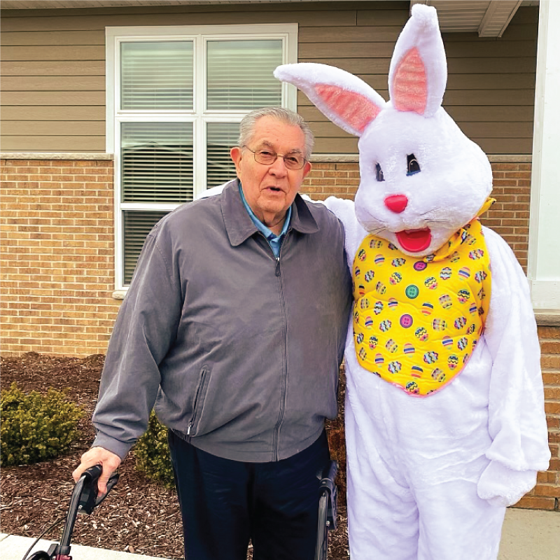 Senior resident posing with Easter Bunny